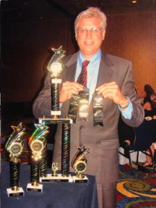 Ed Ladner With his Trophies on a Tables